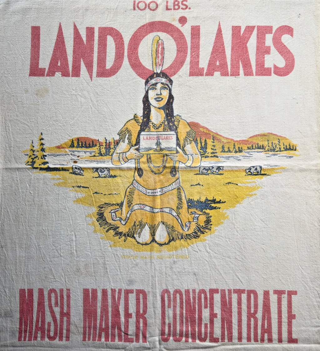 Vintage-style packaging for Lando' Lakes Mash Maker Concentrate with a stylized illustration of a woman holding a box.