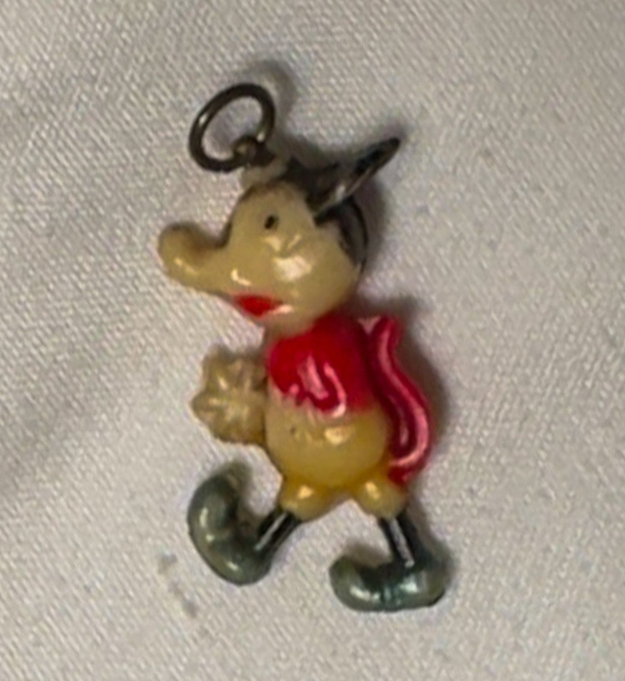 Vintage charm of a character with a red cape and yellow body on a light gray background