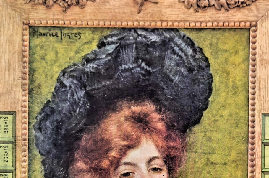 Vintage-style calendar with decorative frame and portrait of a woman with large hairdo.