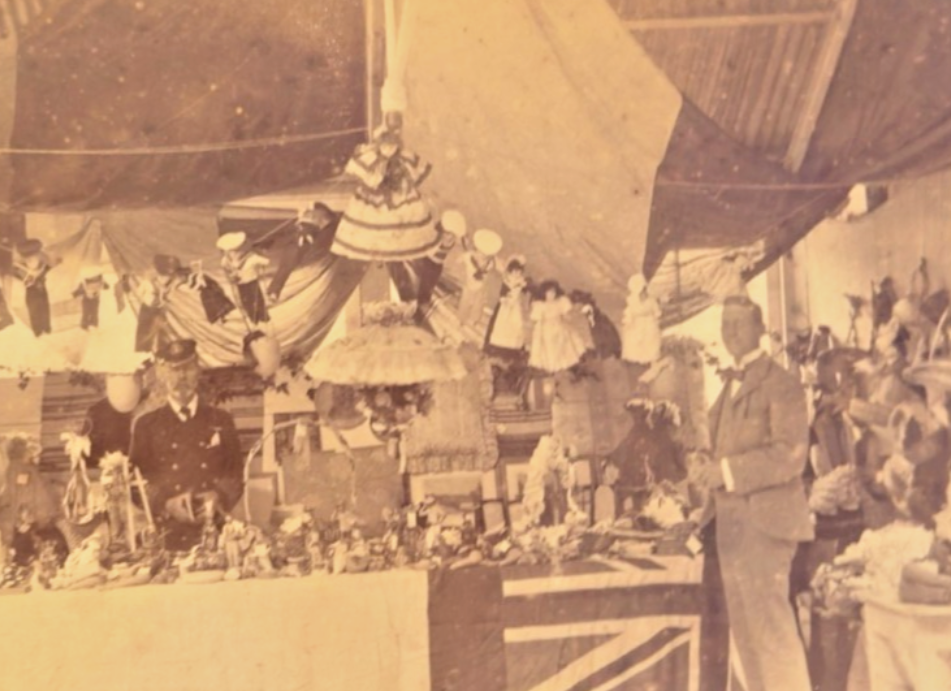 Vintage photograph of a formal event with people and decorations, possibly a wedding or celebration.