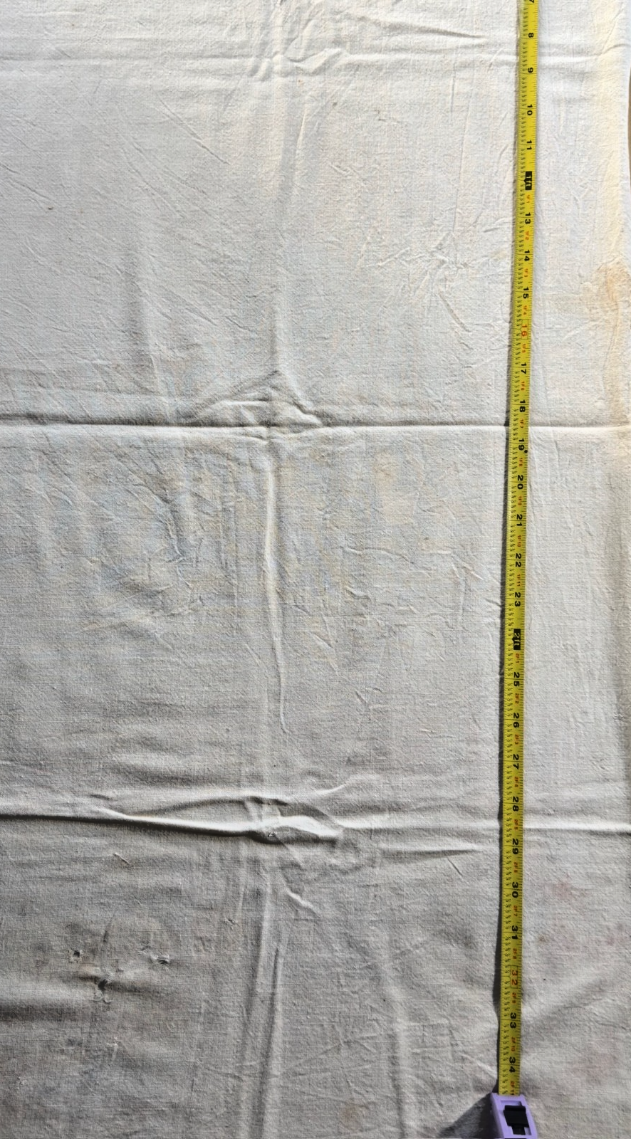 White fabric with a measuring tape on a white background
