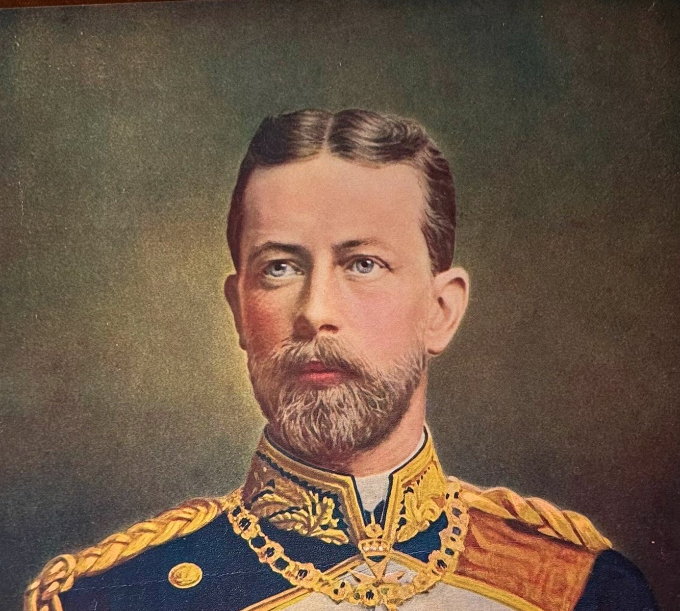 Portrait of a man in formal military attire with gold accents and a dark background