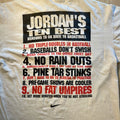 White t-shirt with humorous text about reasons to go back to basketball, featuring a Nike logo.