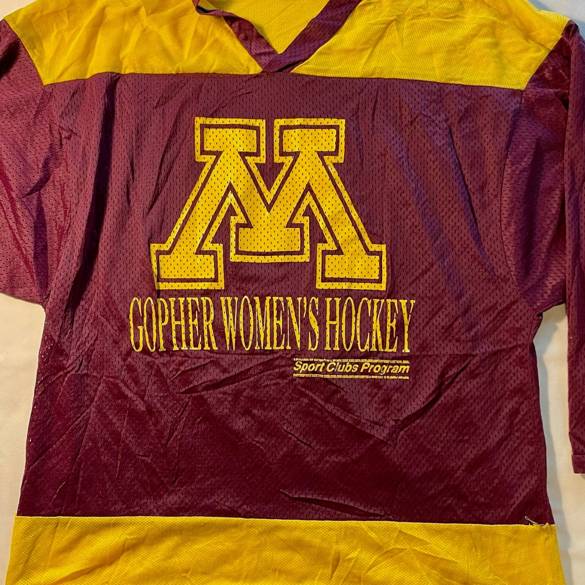 Maroon and yellow hockey jersey with 'Gopher Women's Hockey' text on a white background