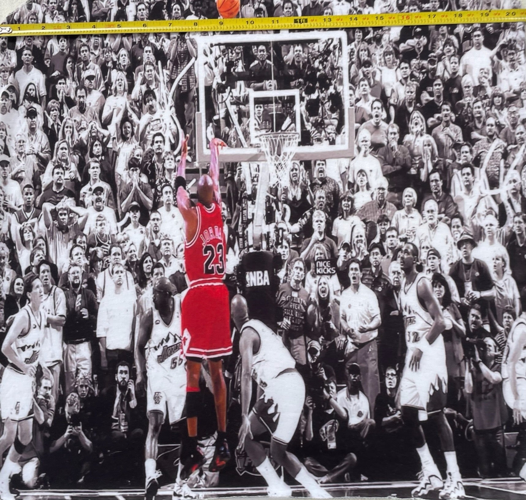Fabric with a basketball player in a red jersey design, displayed on a table.