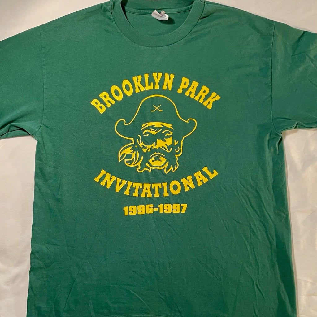 Green t-shirt with yellow 'Brooklyn Park Invitational' text and graphic on a white background