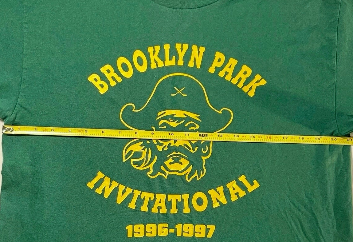 Green t-shirt with yellow text and graphics on a white background