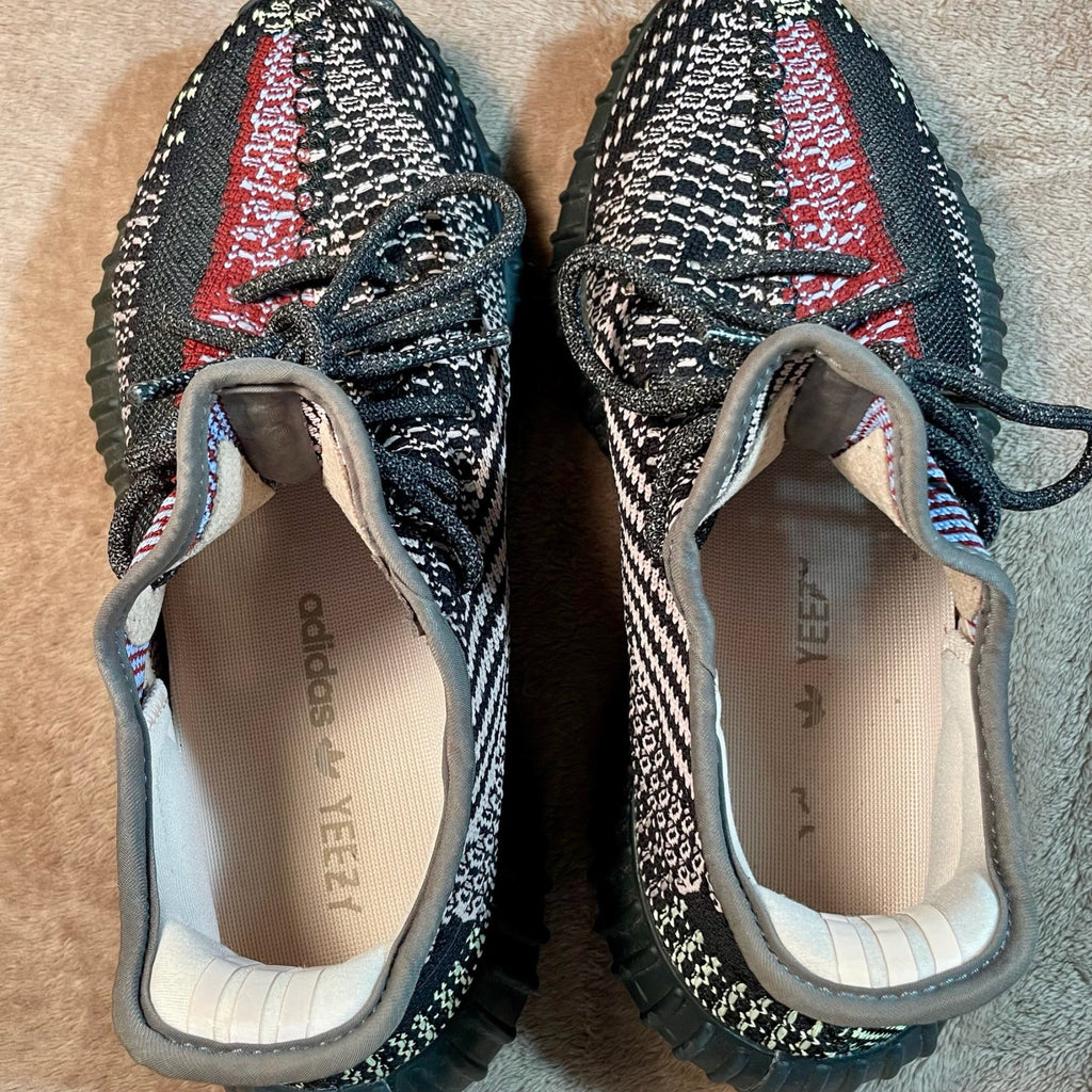 Pair of Adidas Yeezy shoes with textured design on a textured surface