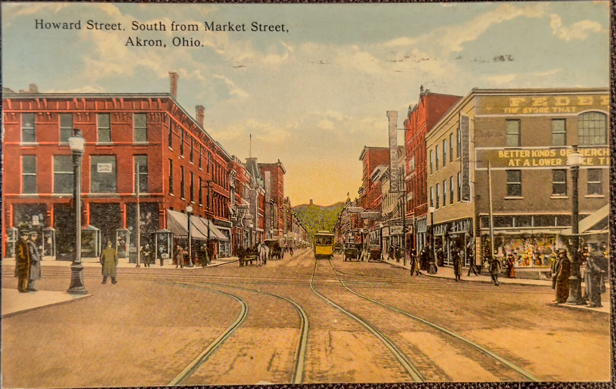 Vintage street scene of Howard Street in Akron, Ohio, with horse-drawn carriages and pedestrians.