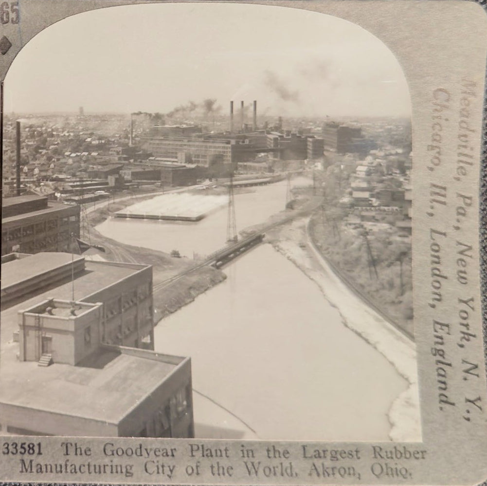 Stereoscopic view of a cityscape with buildings and a river, featuring Keystone View Company branding.