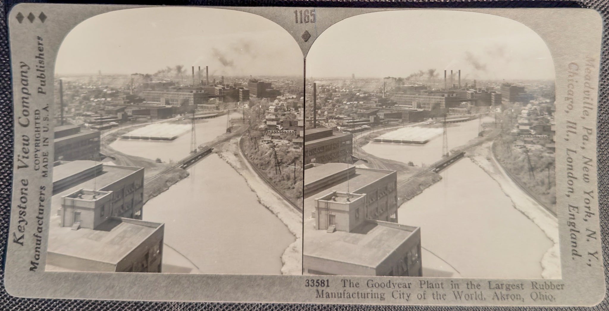 Stereoscopic view of a cityscape with buildings and a river, featuring Keystone View Company branding.