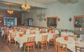 Dining room with tables set for a meal, chairs, and decorative elements.