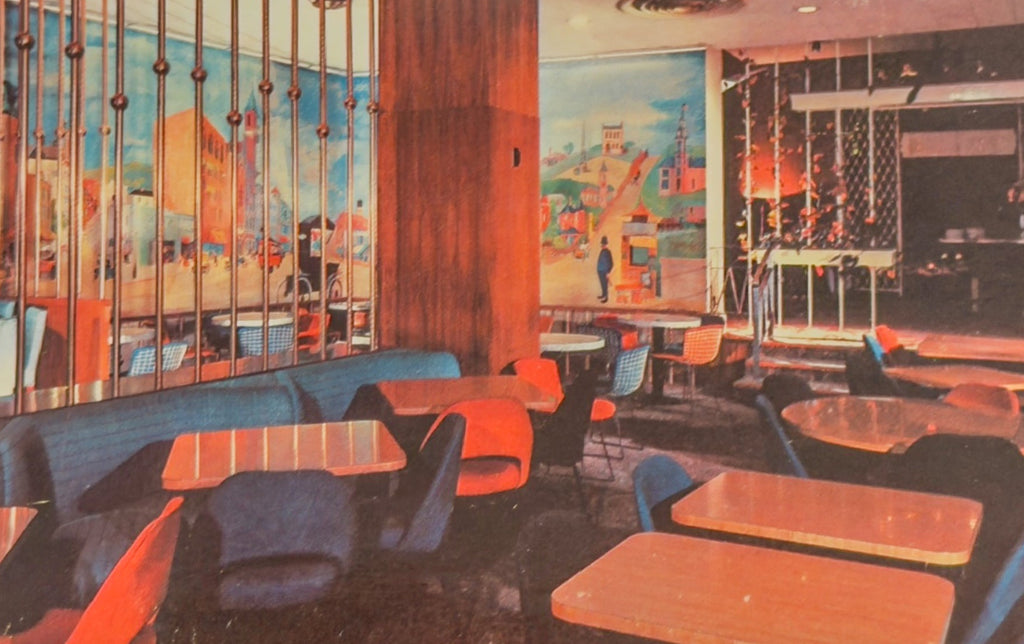 Vintage-style interior of a restaurant with colorful furniture and large windows.