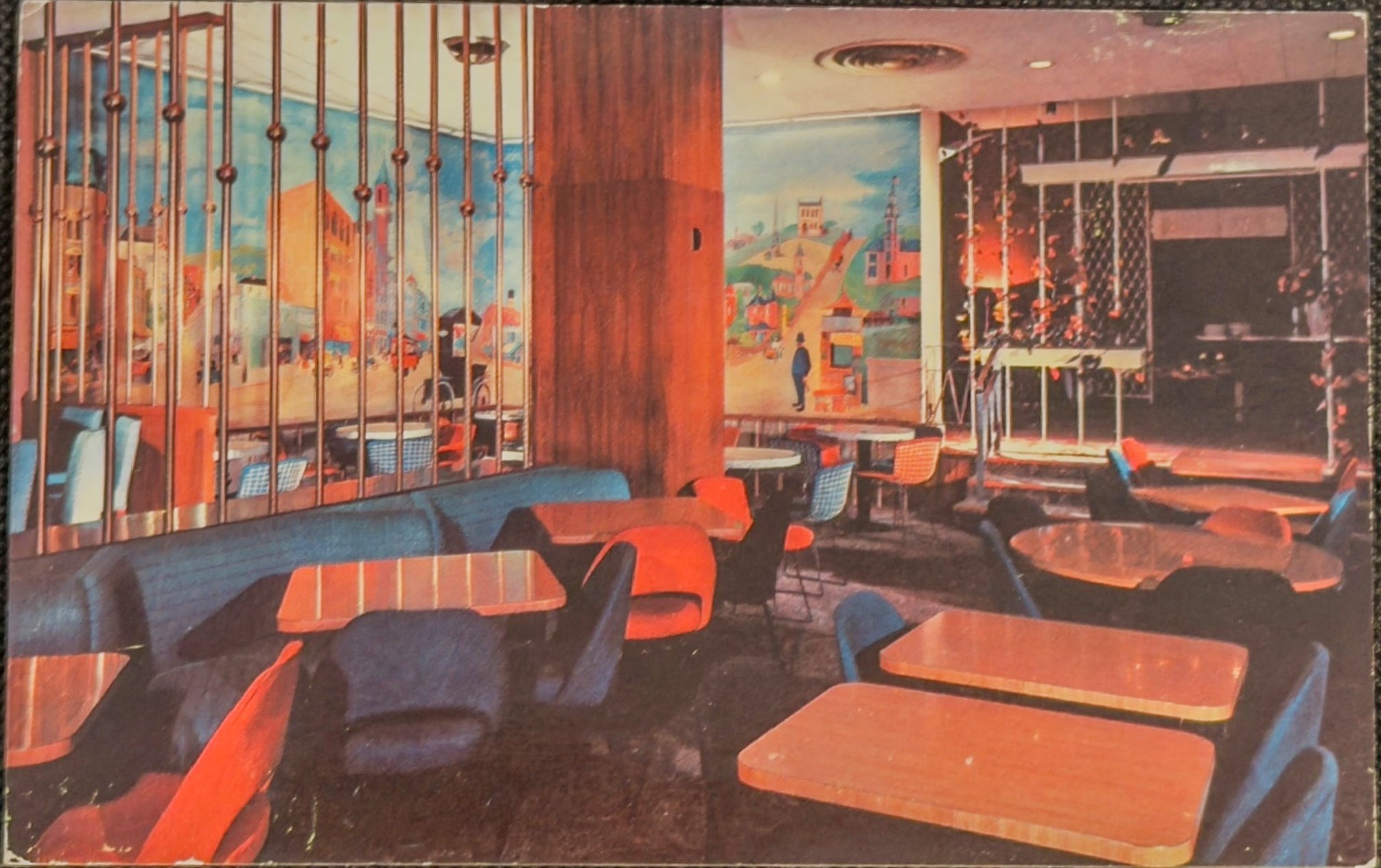 Vintage-style interior of a restaurant with colorful furniture and large windows.
