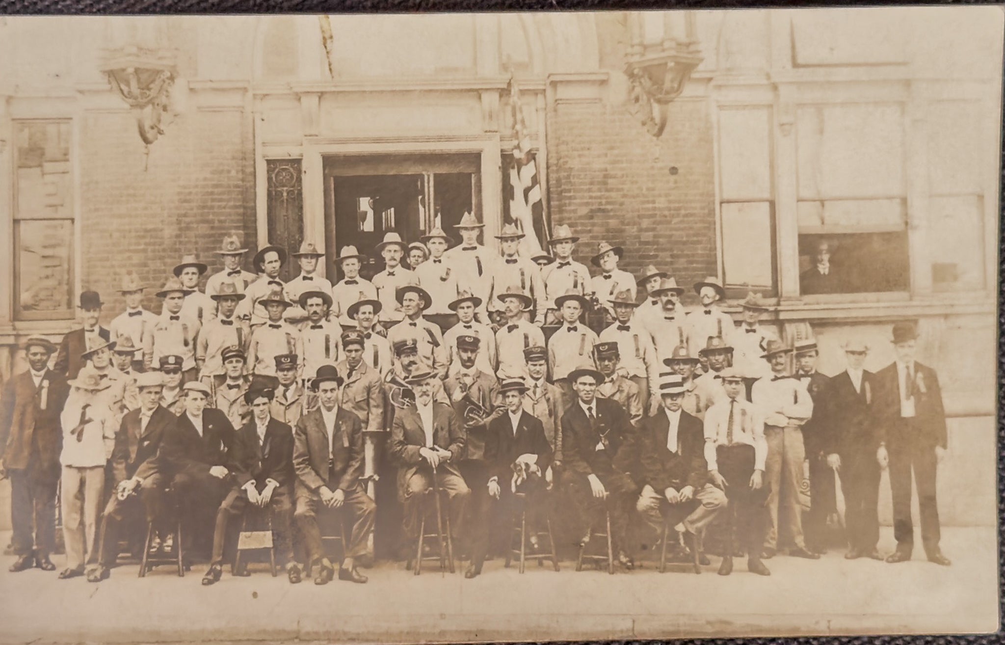 Vintage black and white photo of a group of people in front of a building
