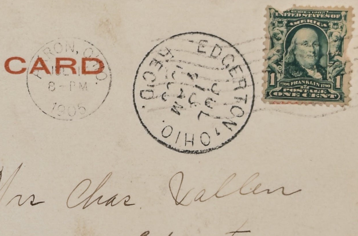 Vintage postcard with postage stamp and postmark, featuring text and a stamp on a beige background.