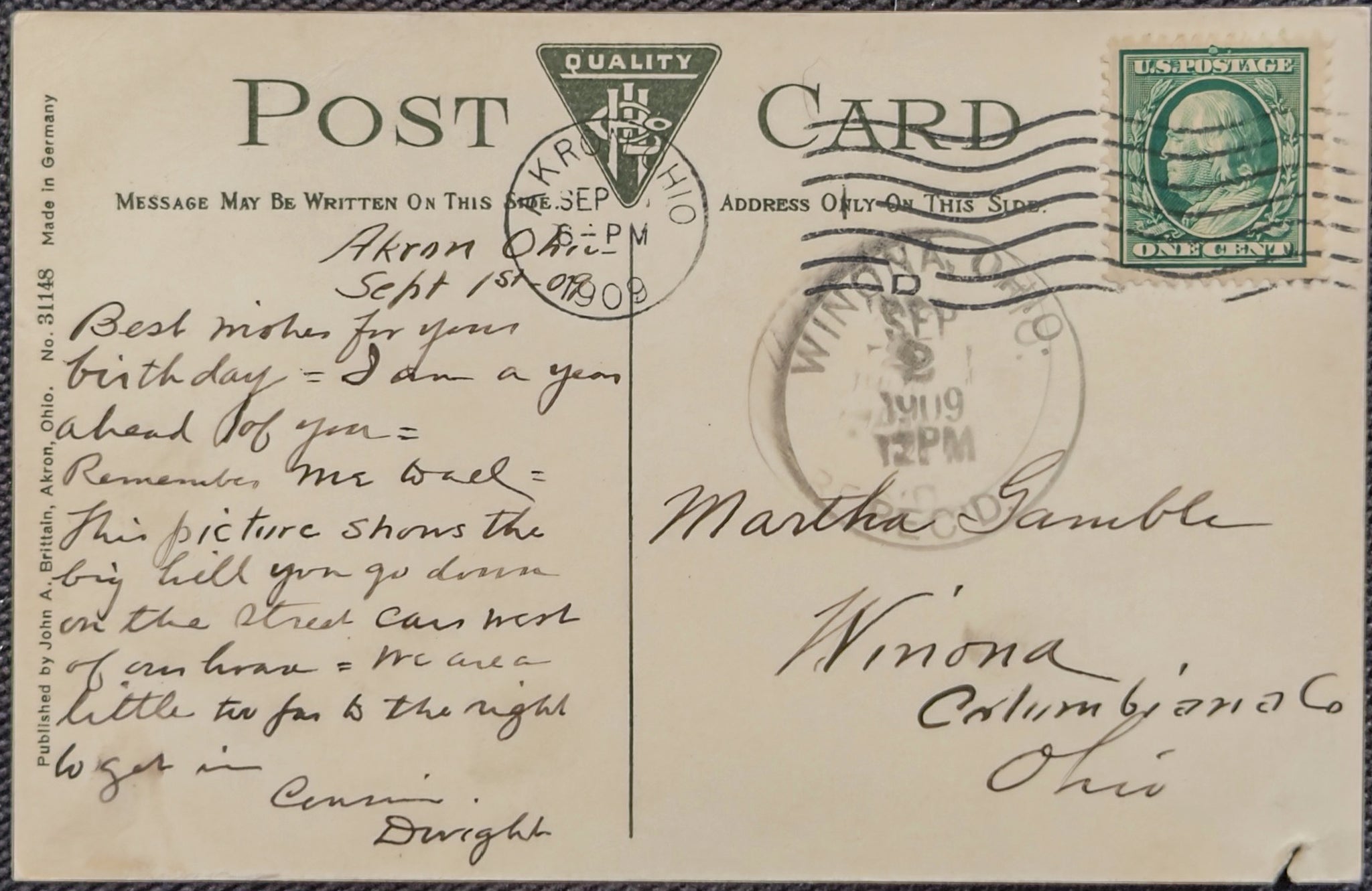 Vintage postcard with text, stamps, and a green stamp on a beige background