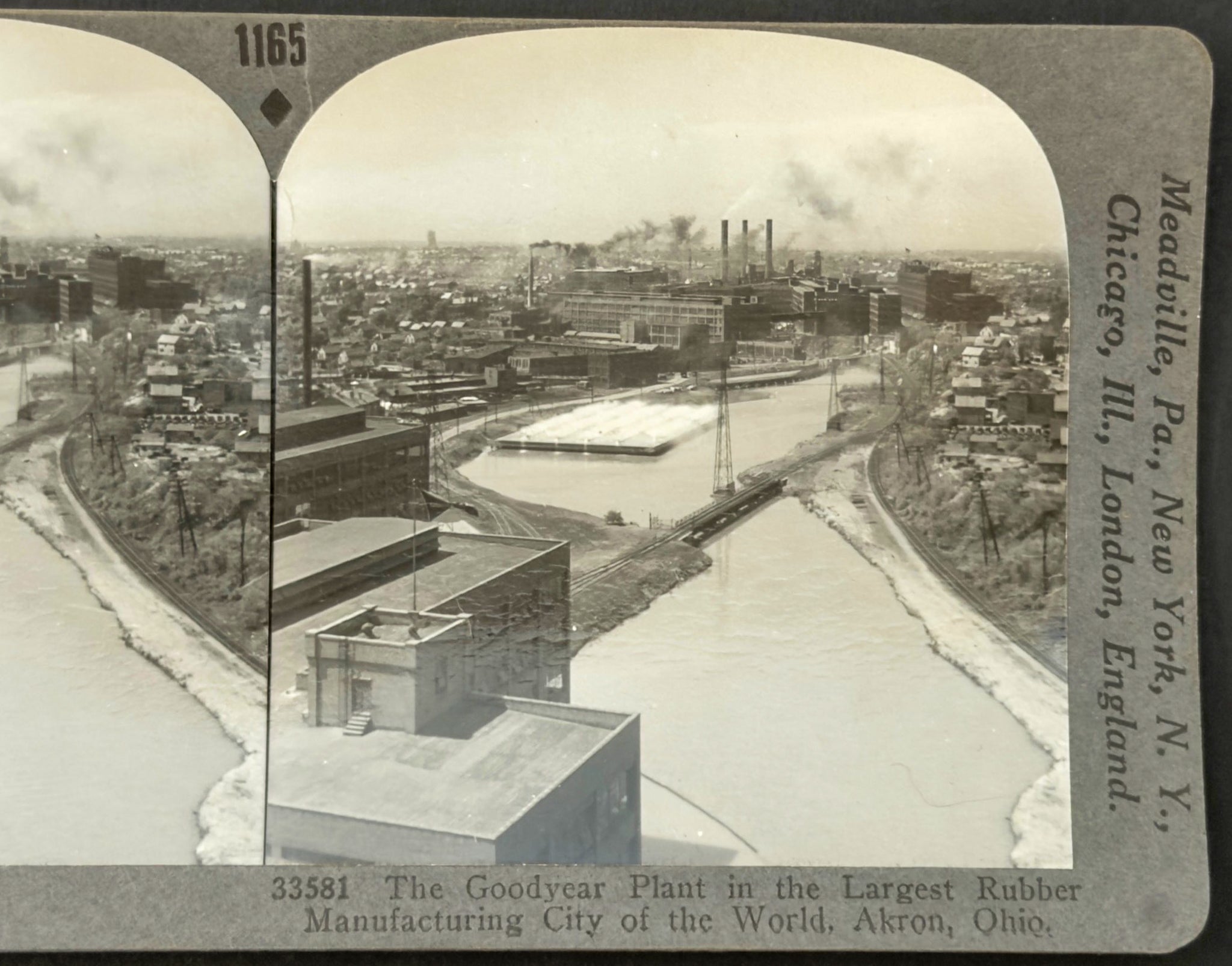 Vintage stereo card of a cityscape with a river and industrial buildings, featuring text on the edges.