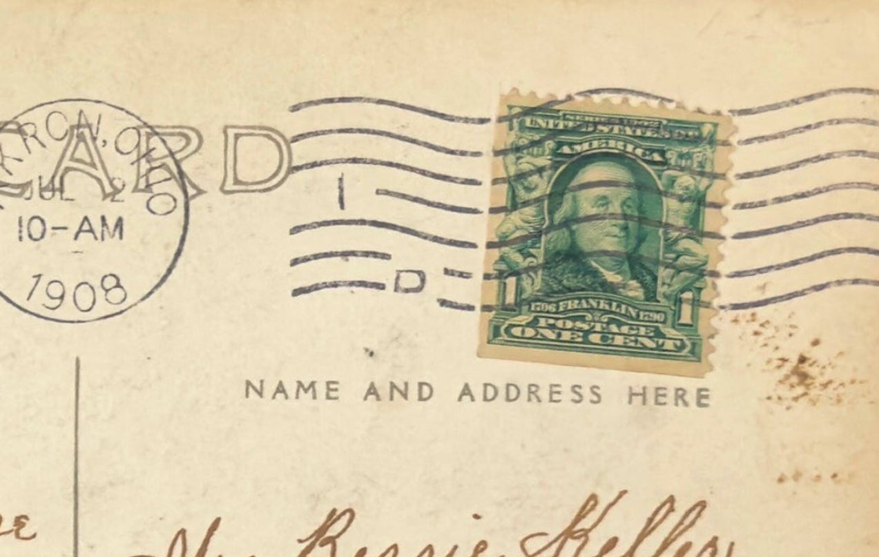 Vintage postcard with postage stamp and handwritten text, featuring a stamp from 1909.