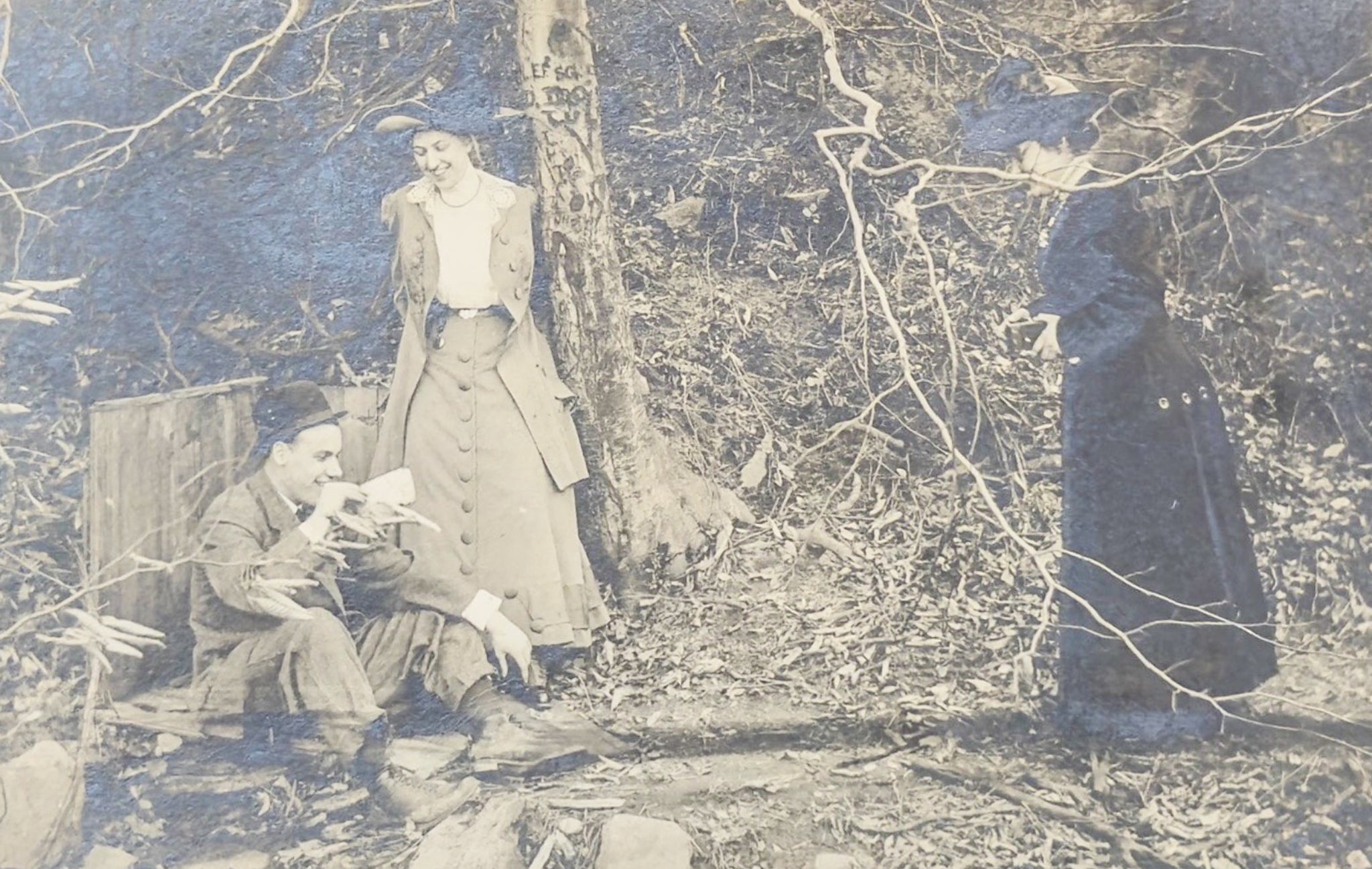 Vintage photograph of a group of people in a forest setting