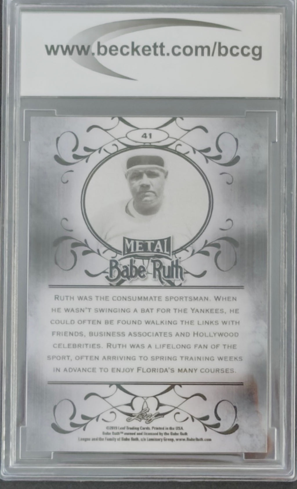 Baseball card featuring Babe Ruth with decorative elements and text on a silver background