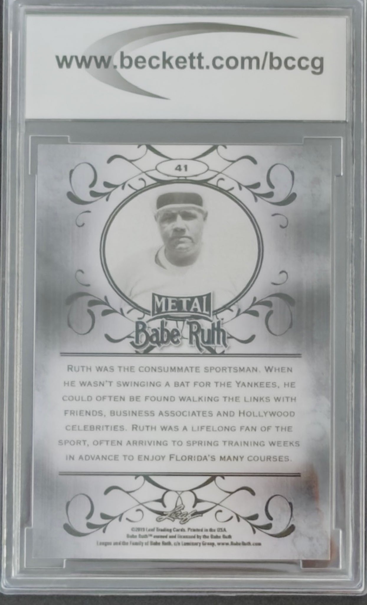 Baseball card featuring Babe Ruth with decorative elements and text on a silver background