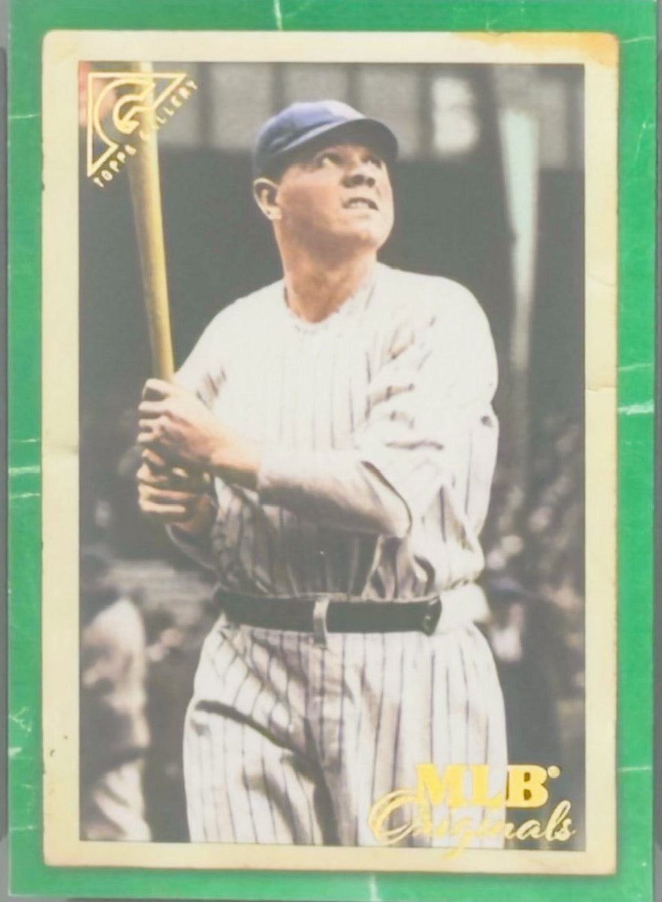 Baseball trading card of Babe Ruth with a grading label on a clear background