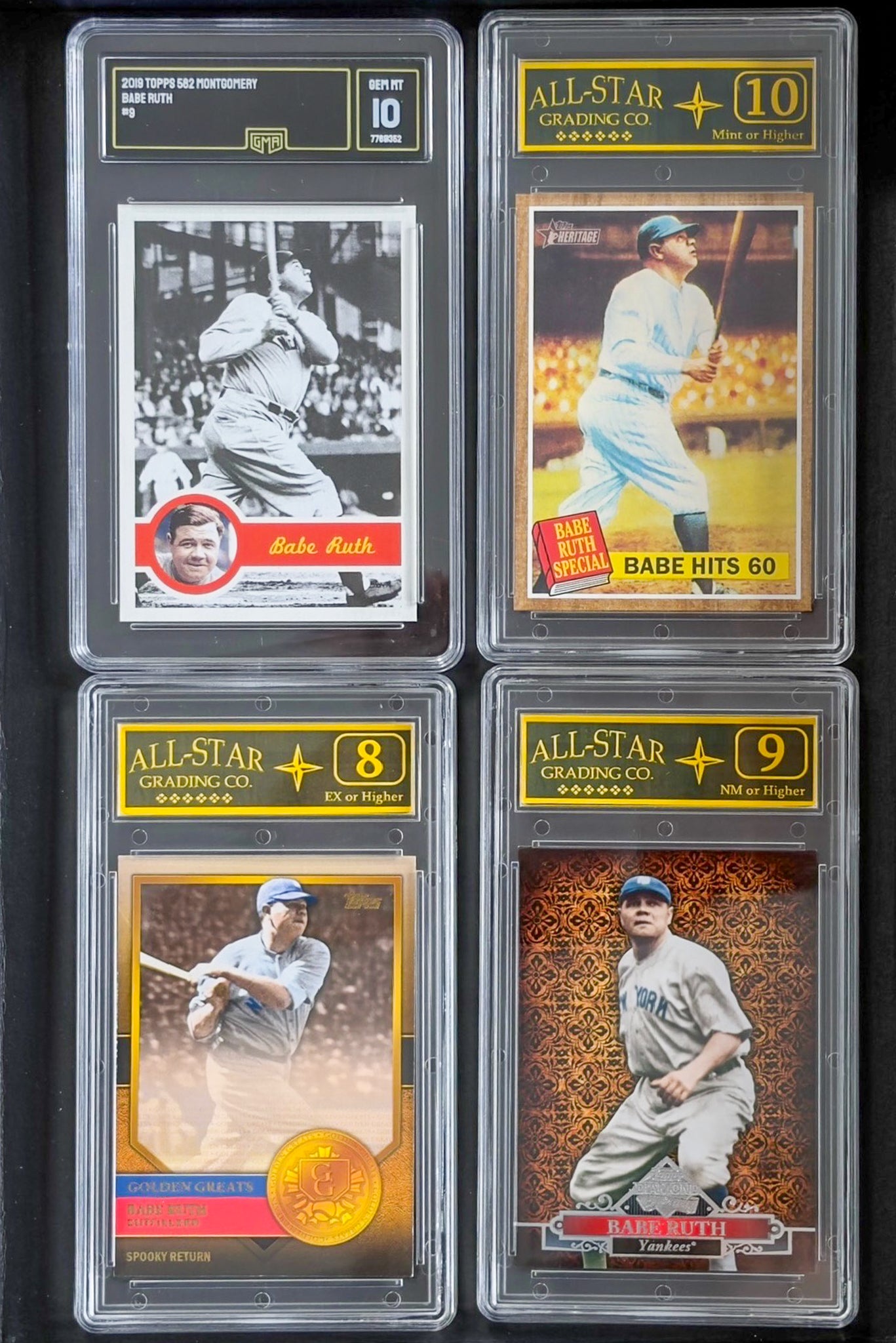 Four baseball trading cards in protective cases with grading labels on a dark background