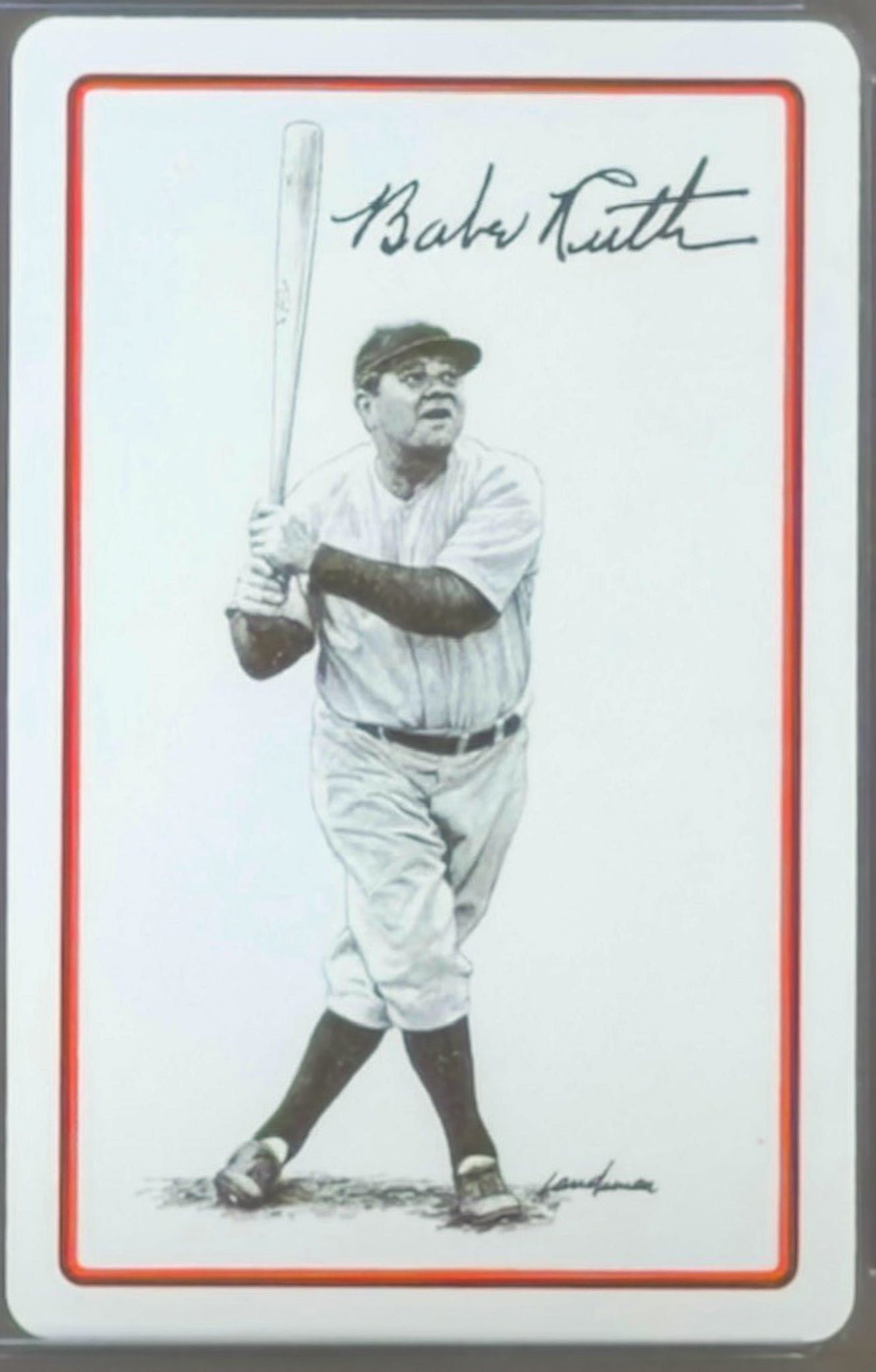 Baseball card of Babe Ruth holding a bat with signature on a white background