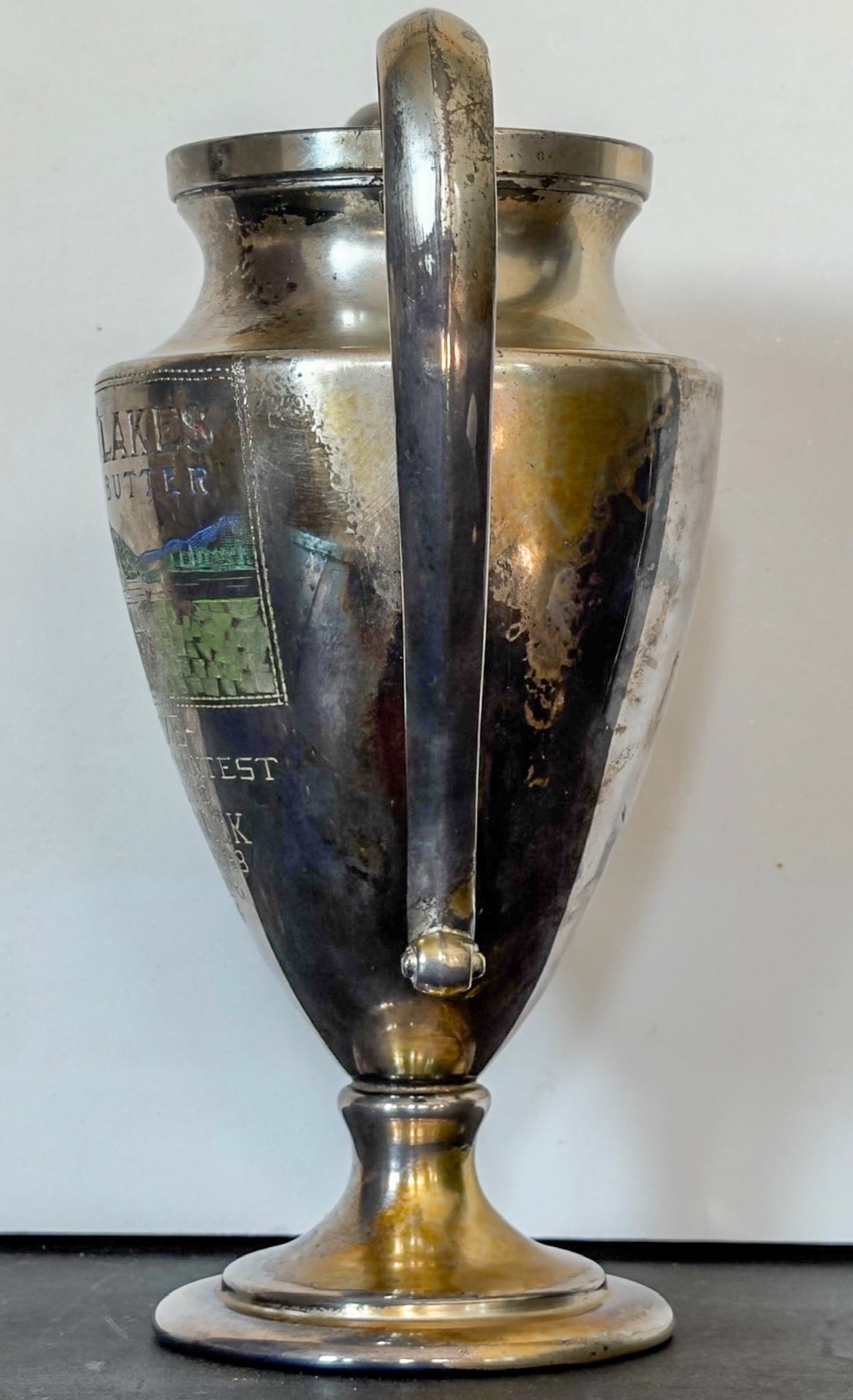 Silver trophy with a handle on a white background