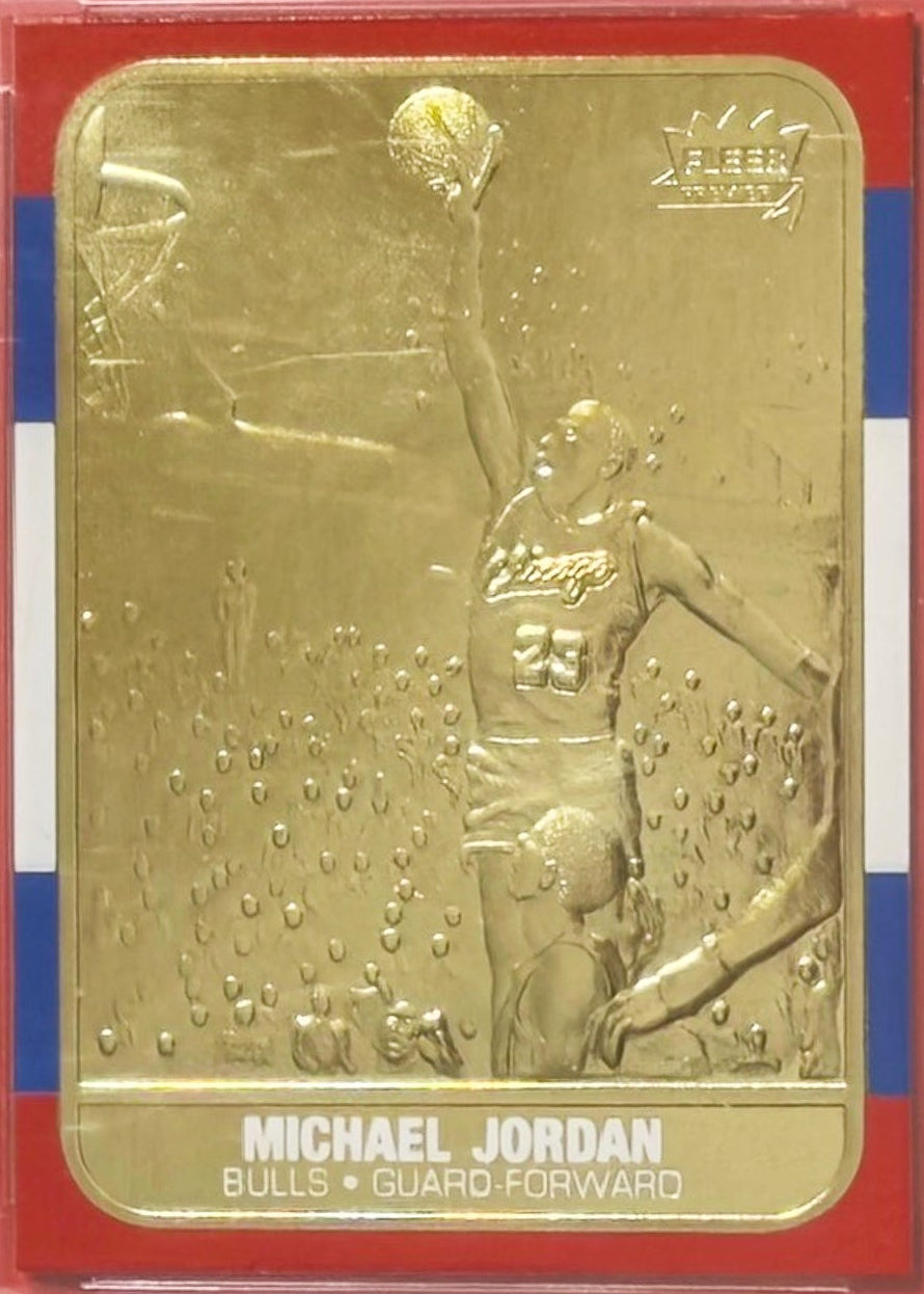 Two gold trading cards of Michael Jordan in display cases with WCG and 10 rating labels.