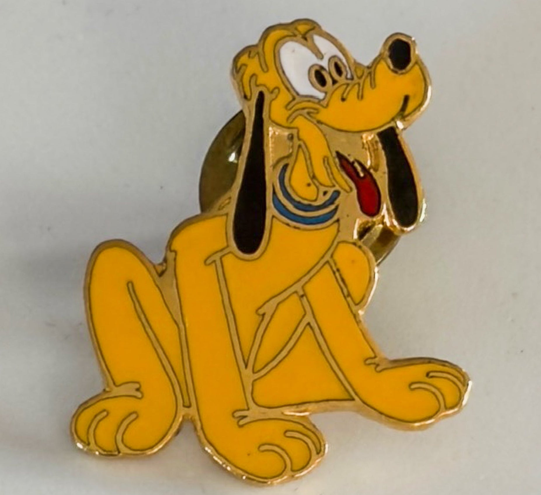 Pluto dog pin on a white background
