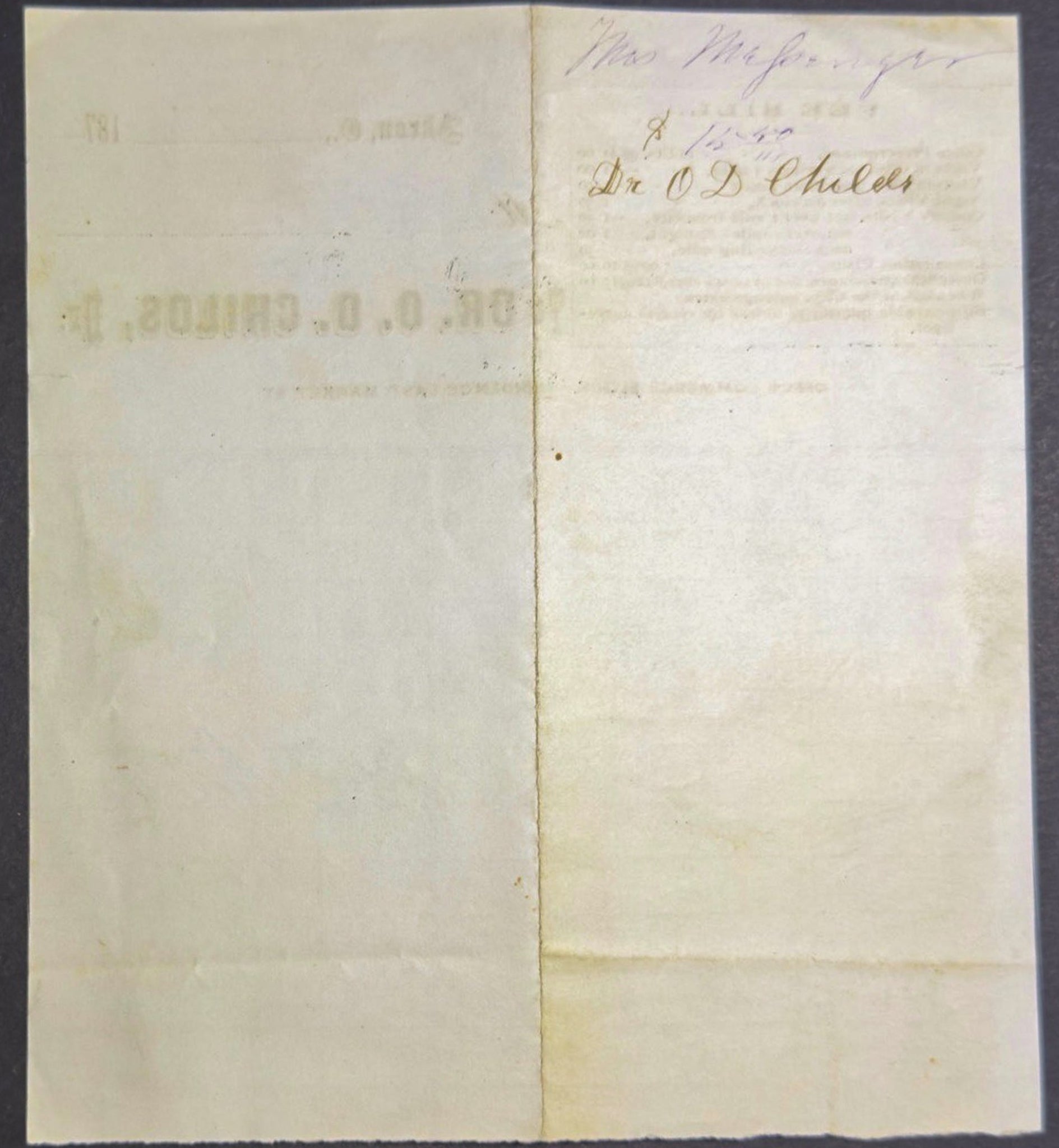 Folded paper with printed text on a dark background