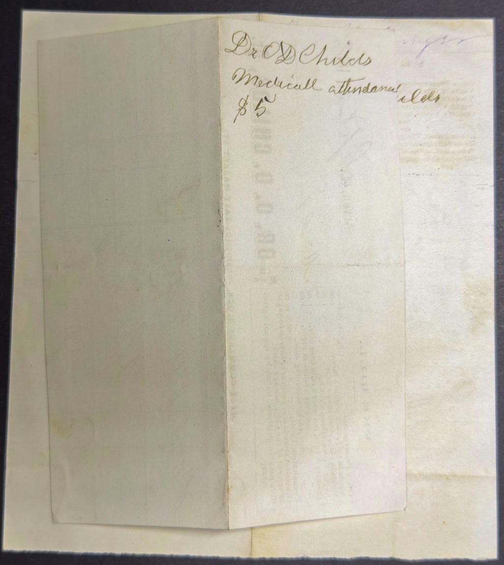 Folded paper with handwritten text on a dark background