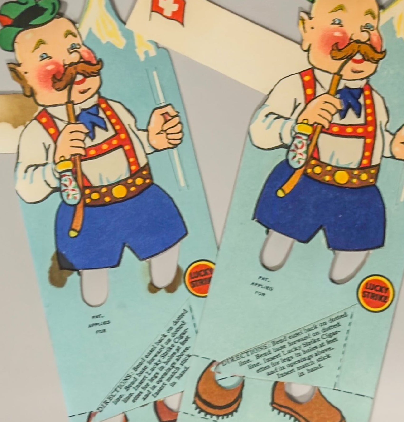 Vintage paper cutout of a character in traditional attire with a Swiss flag, on a light gray background.